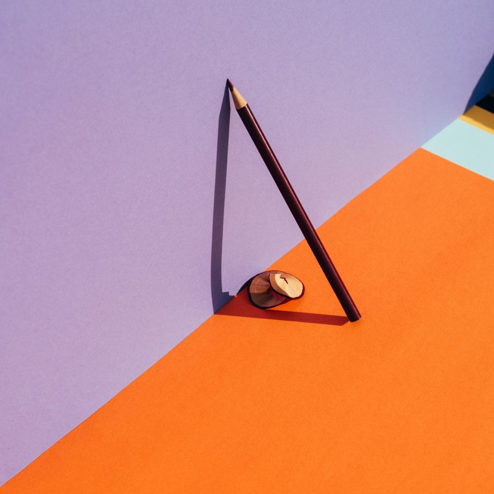 pencil-and-shavings-from-sharpening-leaning-on-the-violet-wall-